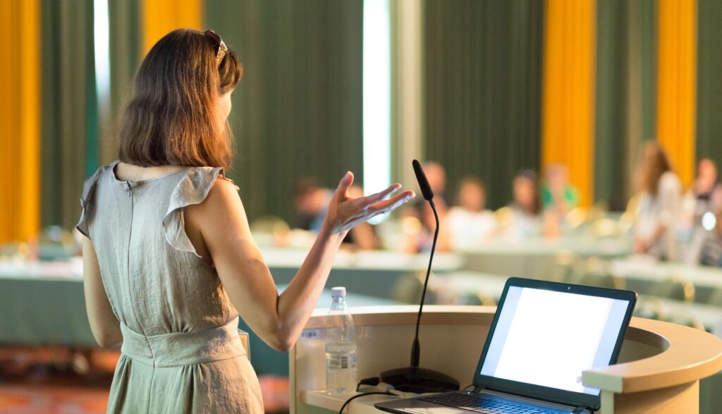 Female speaker giving presentation at first-time home buyer workshop