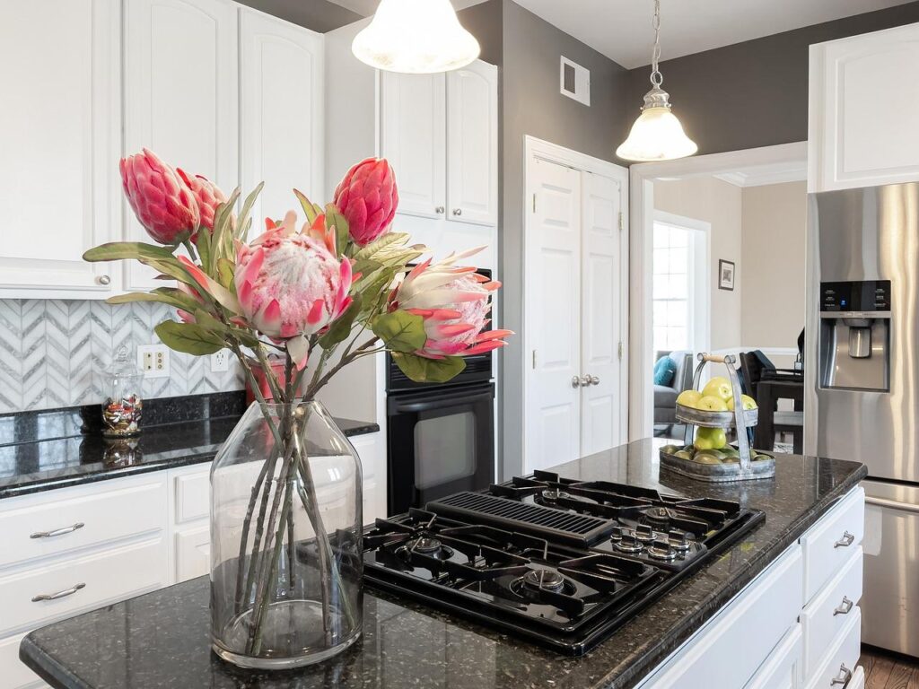 A modern kitchen staged for a quick sale pictures a kitchen with flowers and accessories