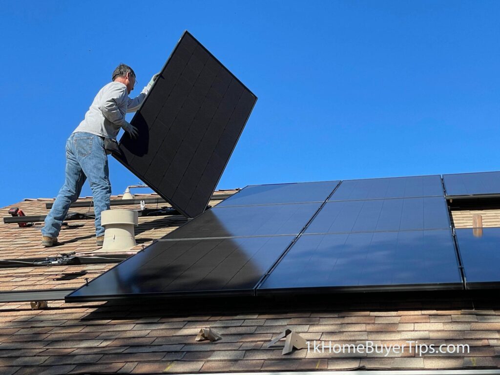 man installing solar panels on his home's roof